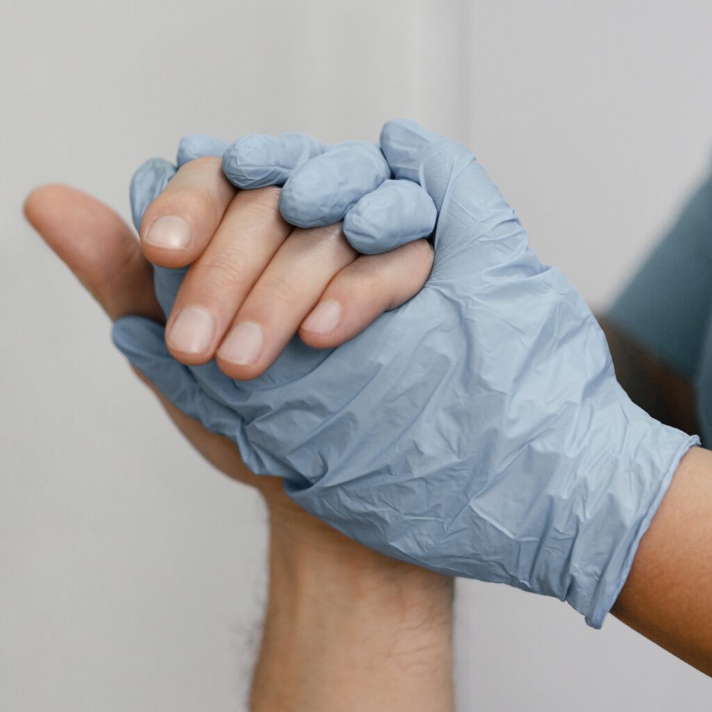 close up nurse holding patient s hand